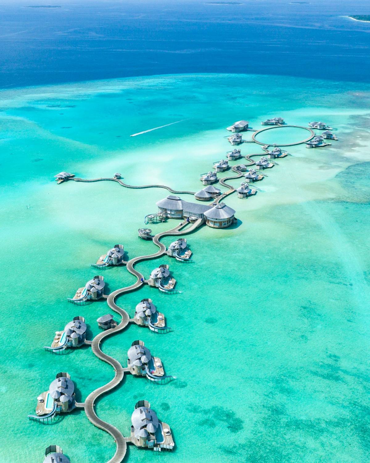 Overwater villas over a turquoise lagoon in the Maldives